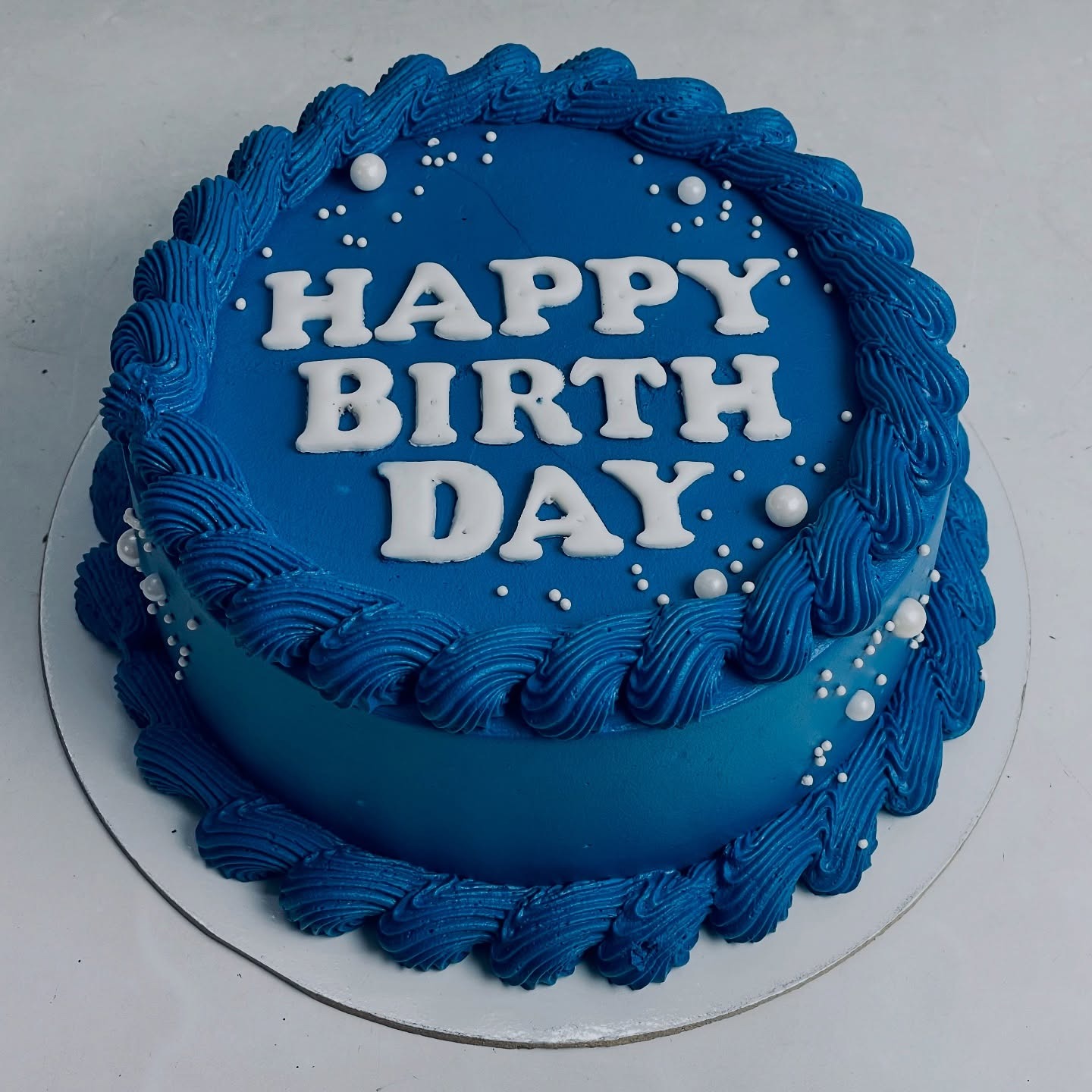 Blue birthday cake with white lettering