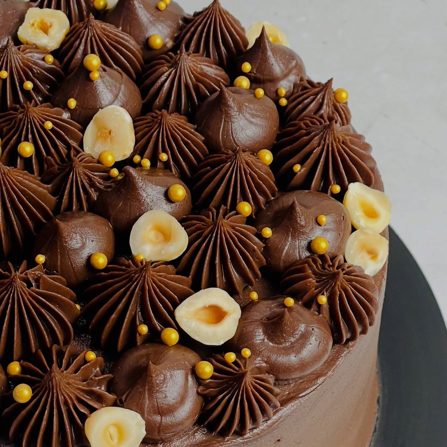 Handcrafted chocolate celebration cake by Cakestagram